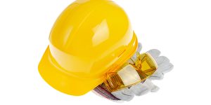 Yellow plastic hard hat glasses and protective gloves isolated o