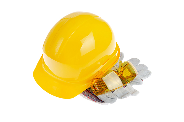Yellow plastic hard hat glasses and protective gloves isolated o